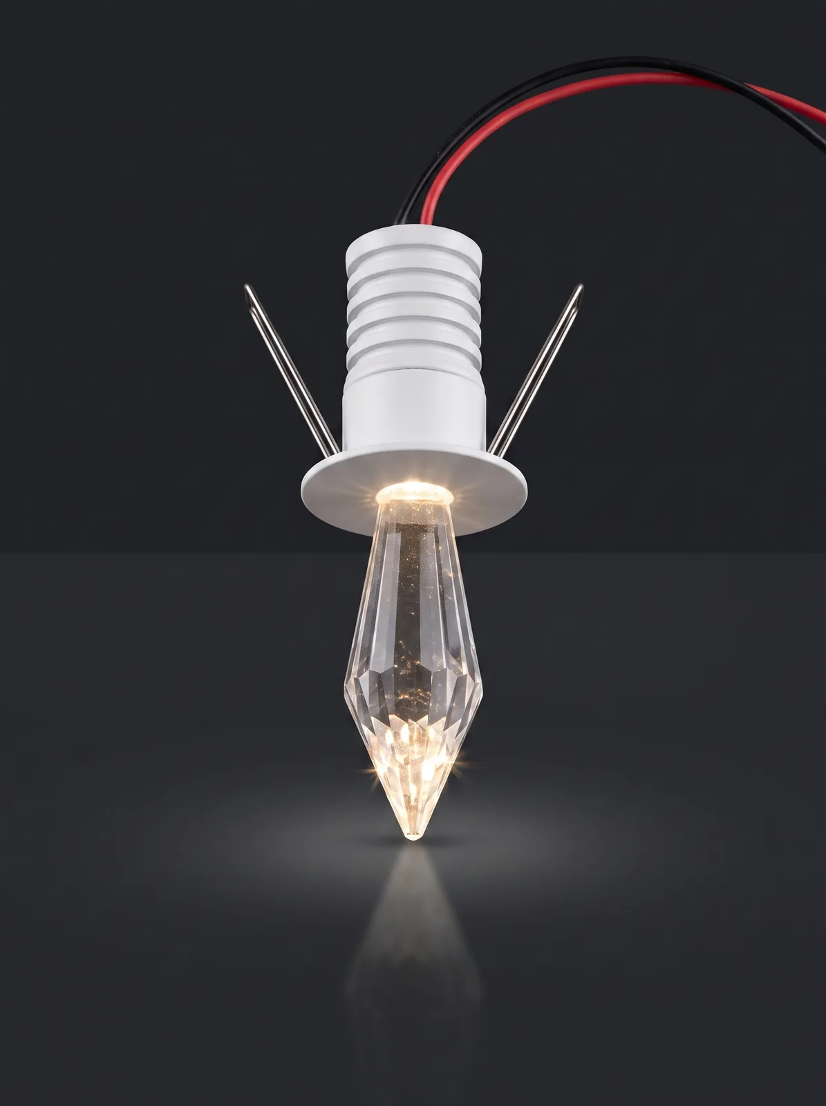 A crystal starlight spotlight with a faceted spear tip, lit warm