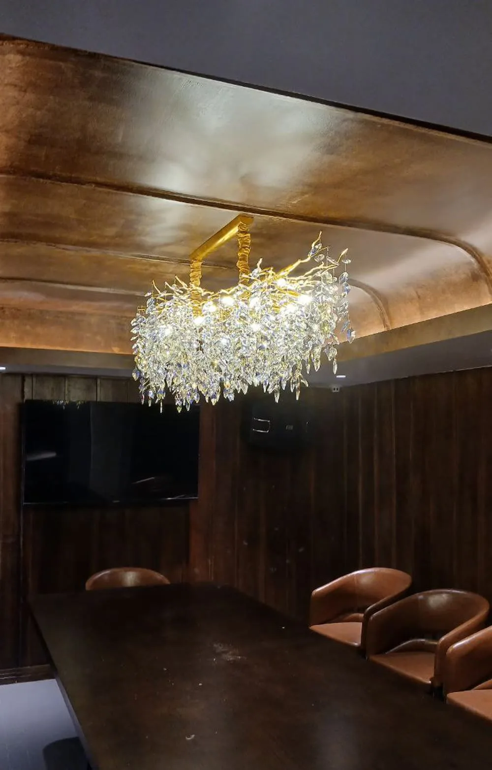 A crystal branch chandelier over a private dining table