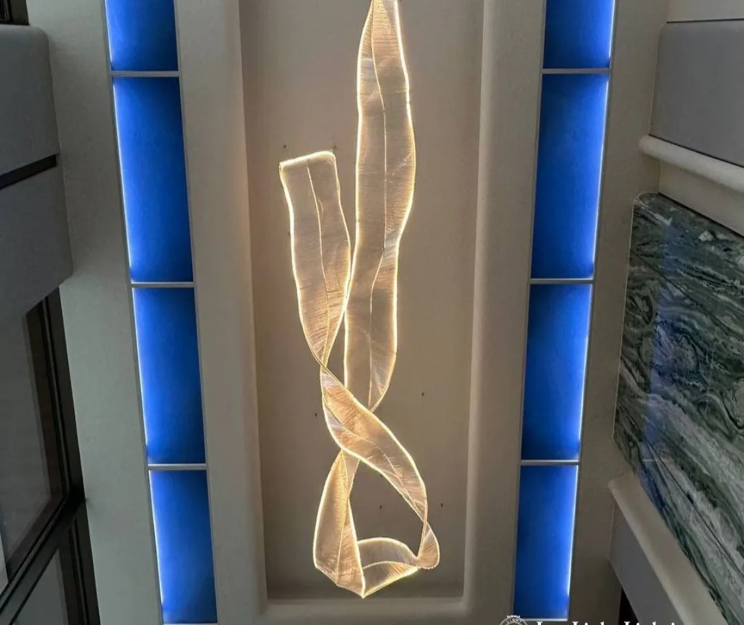 An illuminated ribbon light feature set into a wall niche